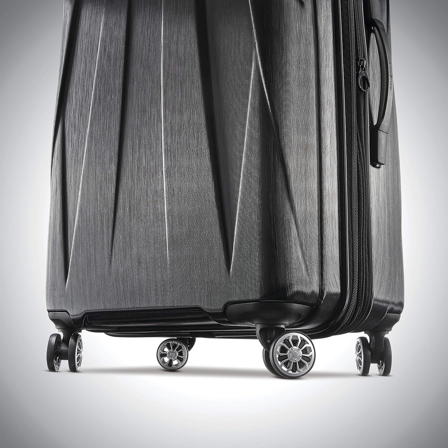 Close-up of the spinner wheels and brushed hardside shell reassures shoppers the case rolls smoothly and looks durable.