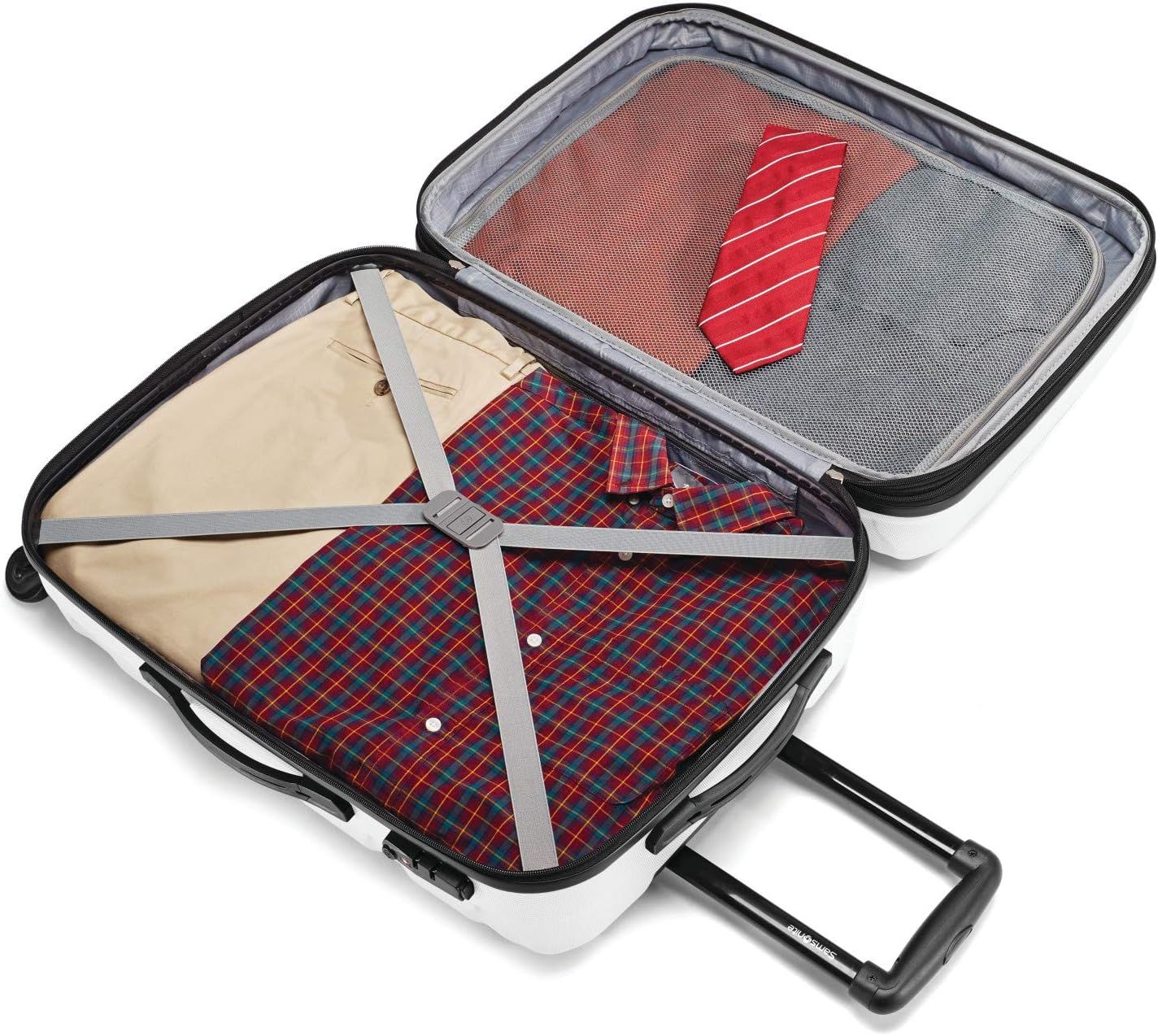 Shows the open suitcase packed with shirts, trousers and a tie, so shoppers can picture everyday packing.