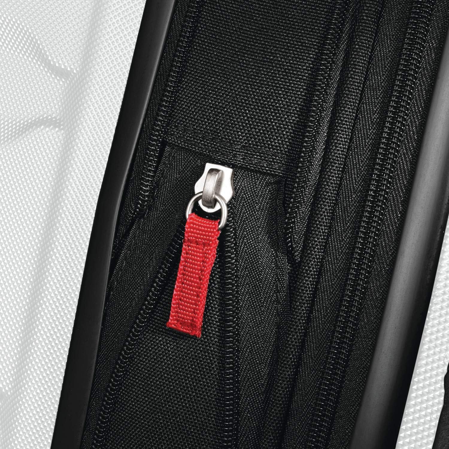 Close-up of the expansion zipper with a red pull tab shows the easy-to-grip zip that opens the extra space.
