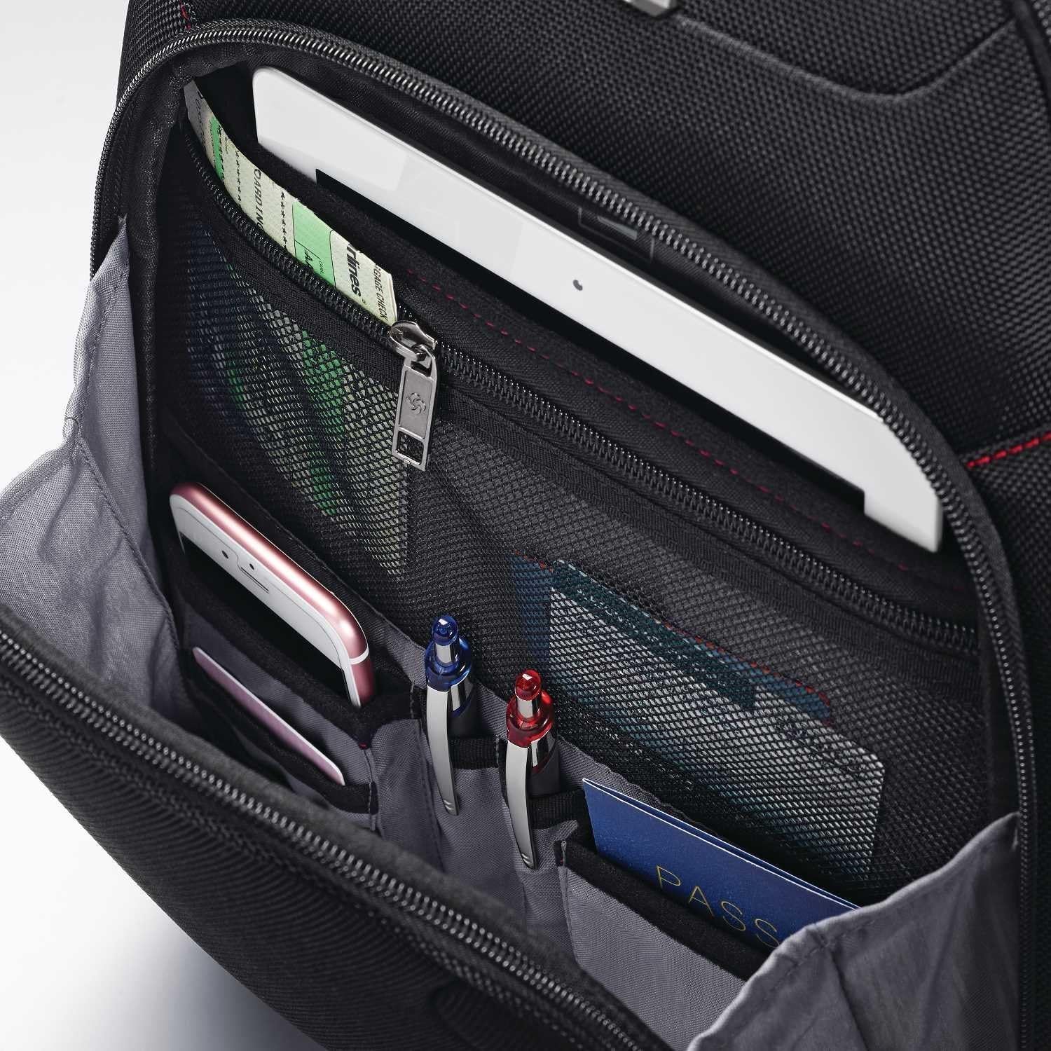 Close-up of pockets holding a phone, tablet, pens and passport shows where everyday items fit.