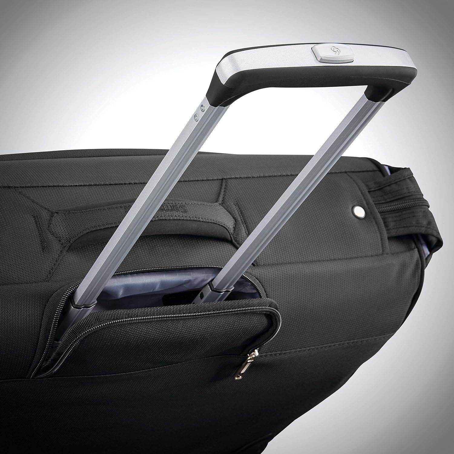 Shows the extended handle and bag body so shoppers see the rolling design is built for easy pulling.