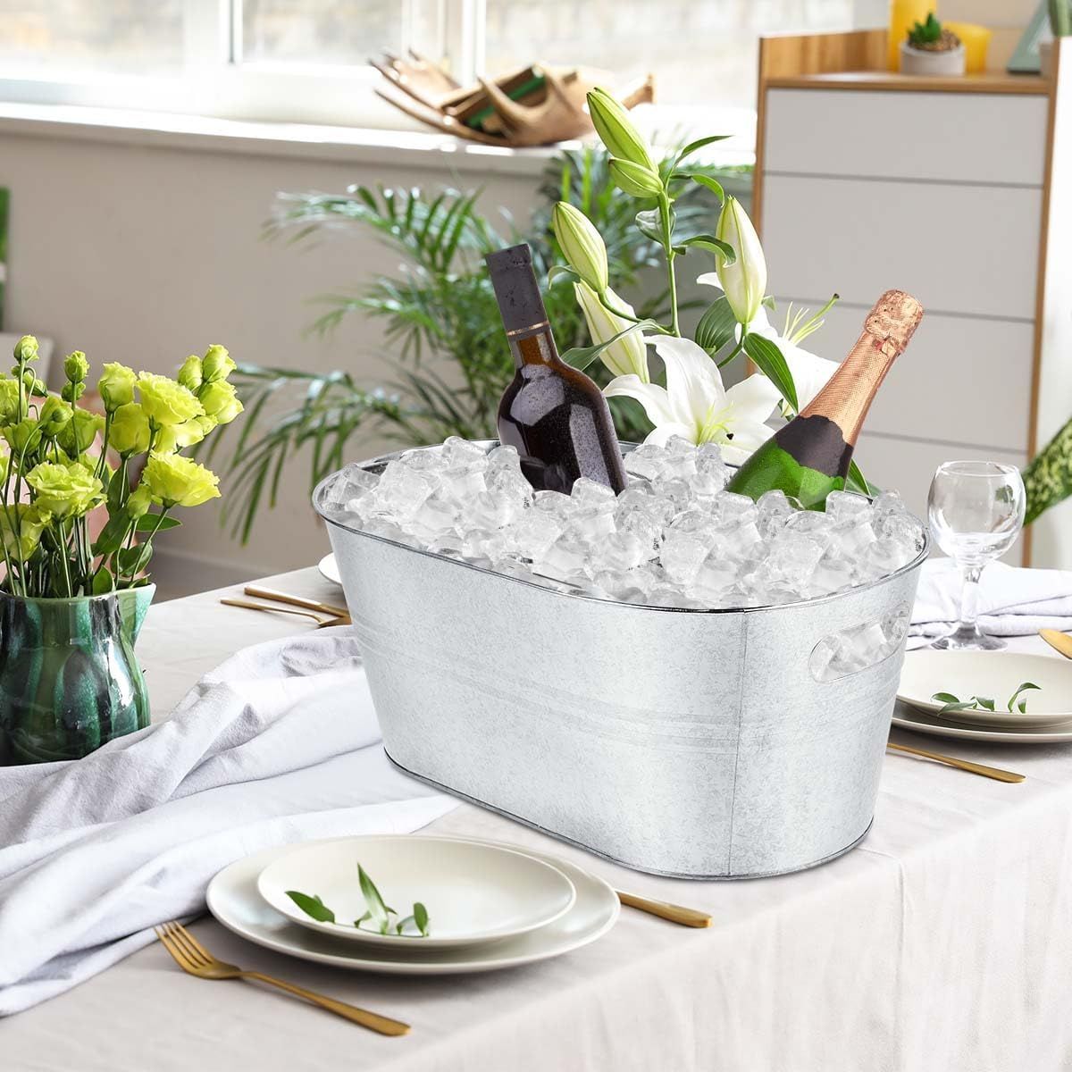 Shows the tub styled on a dining table with ice and bottles for an elegant entertaining look.