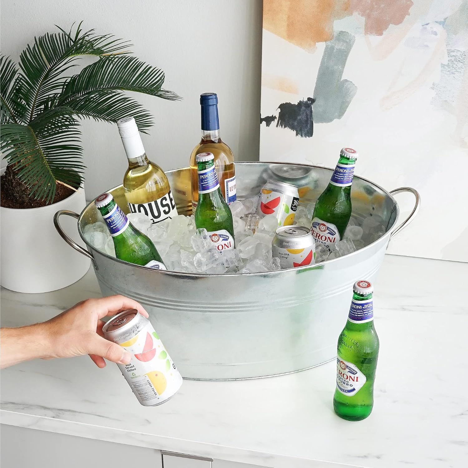 Shows the bucket styled in a living space with ice and drinks to inspire entertaining.