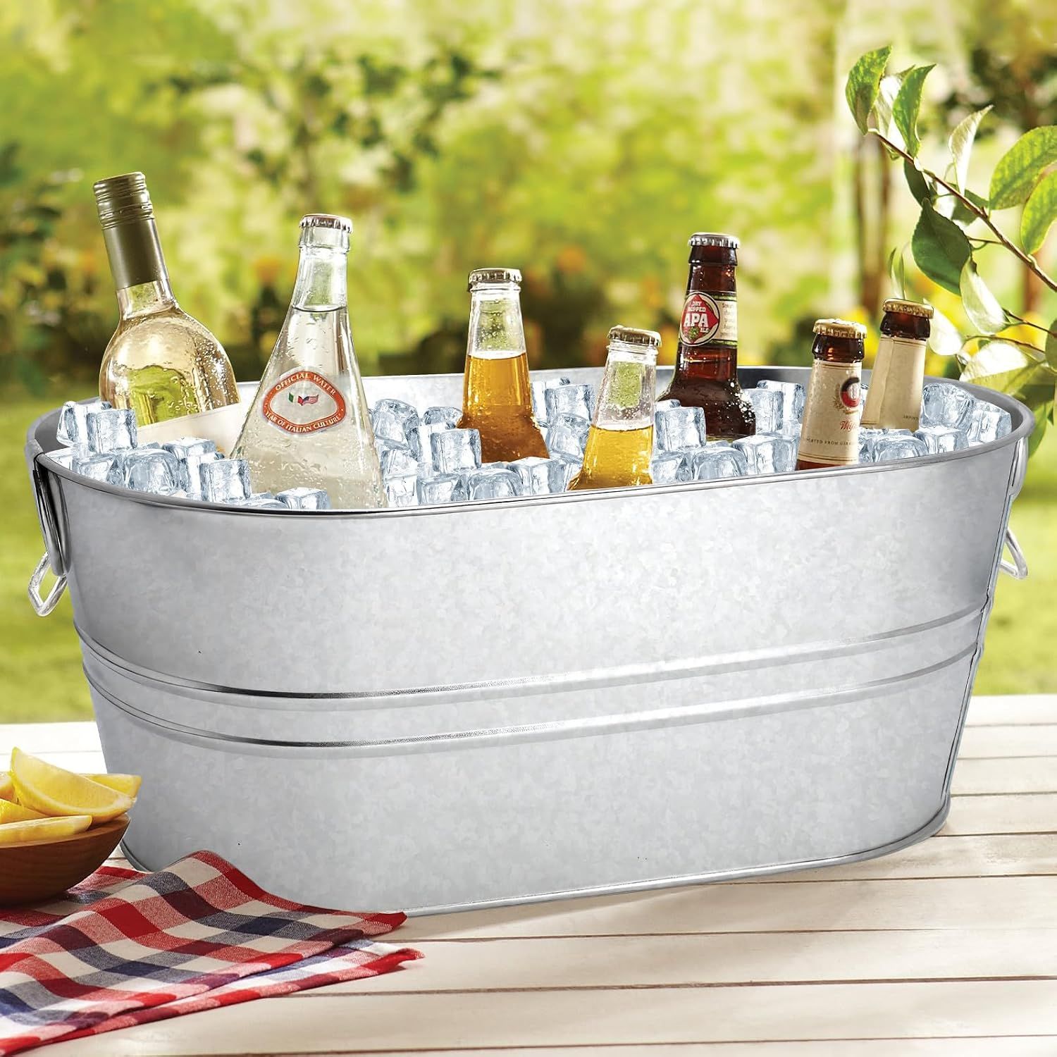 Shows the tub filled with chilled drinks outdoors to communicate its practical everyday use for gatherings.