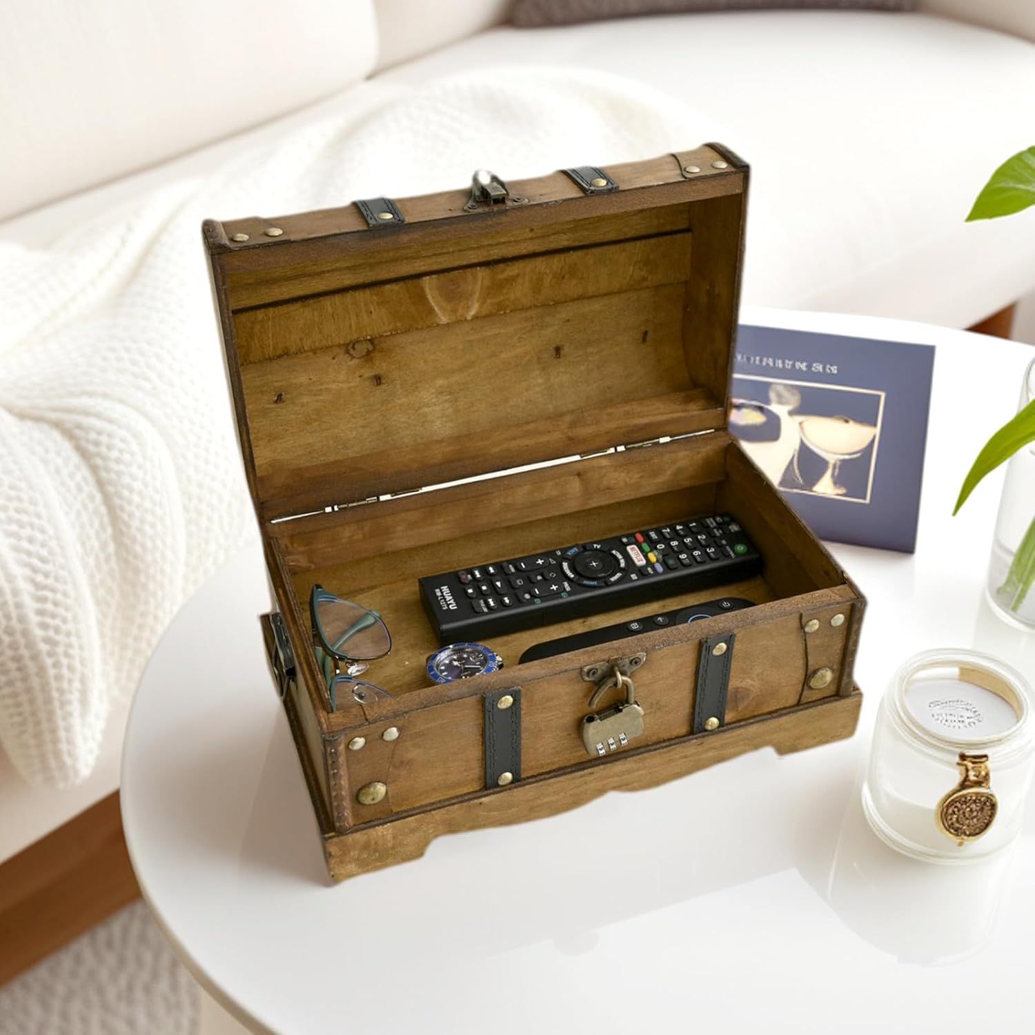 Shows the chest used to store everyday items like remotes and glasses in a living space. Reassures shoppers that stored items stay private with the combination lock.