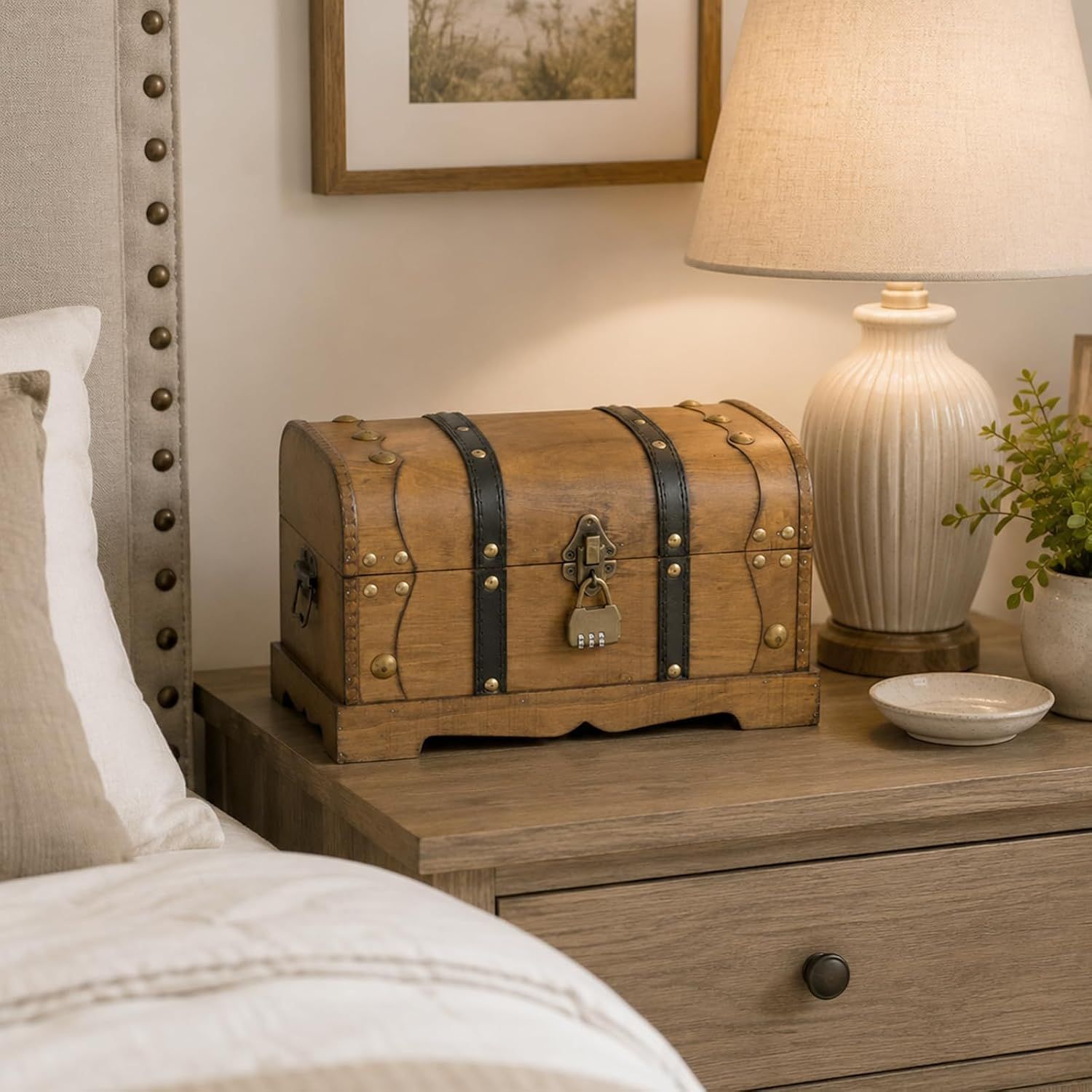 Presents the small trunk as a decorative bedside storage piece that fits neatly in a bedroom.