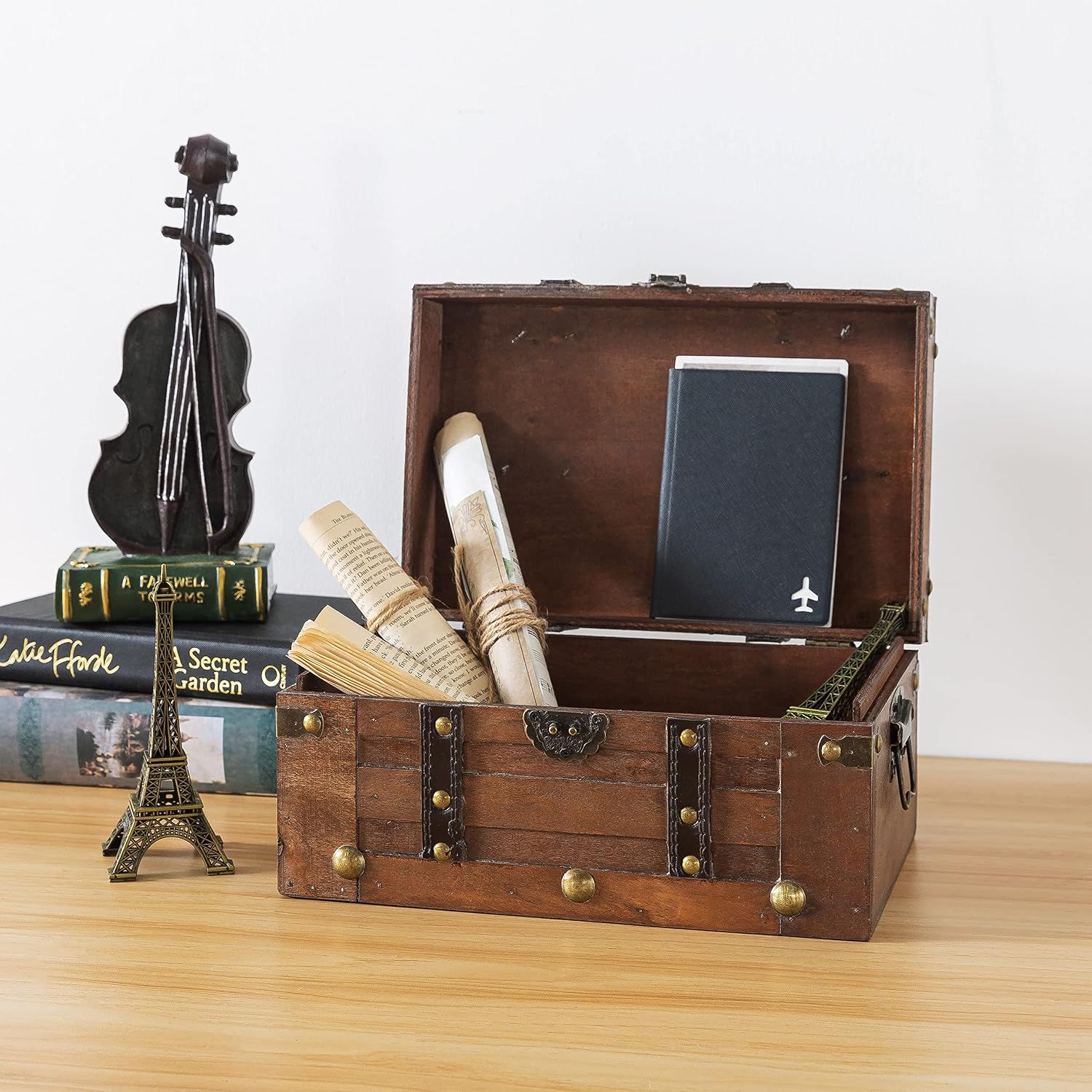 Shows the trunk styled open with documents and a passport to suggest its storage uses. Presents the trunk as an attractive vintage piece that doubles as organized storage.