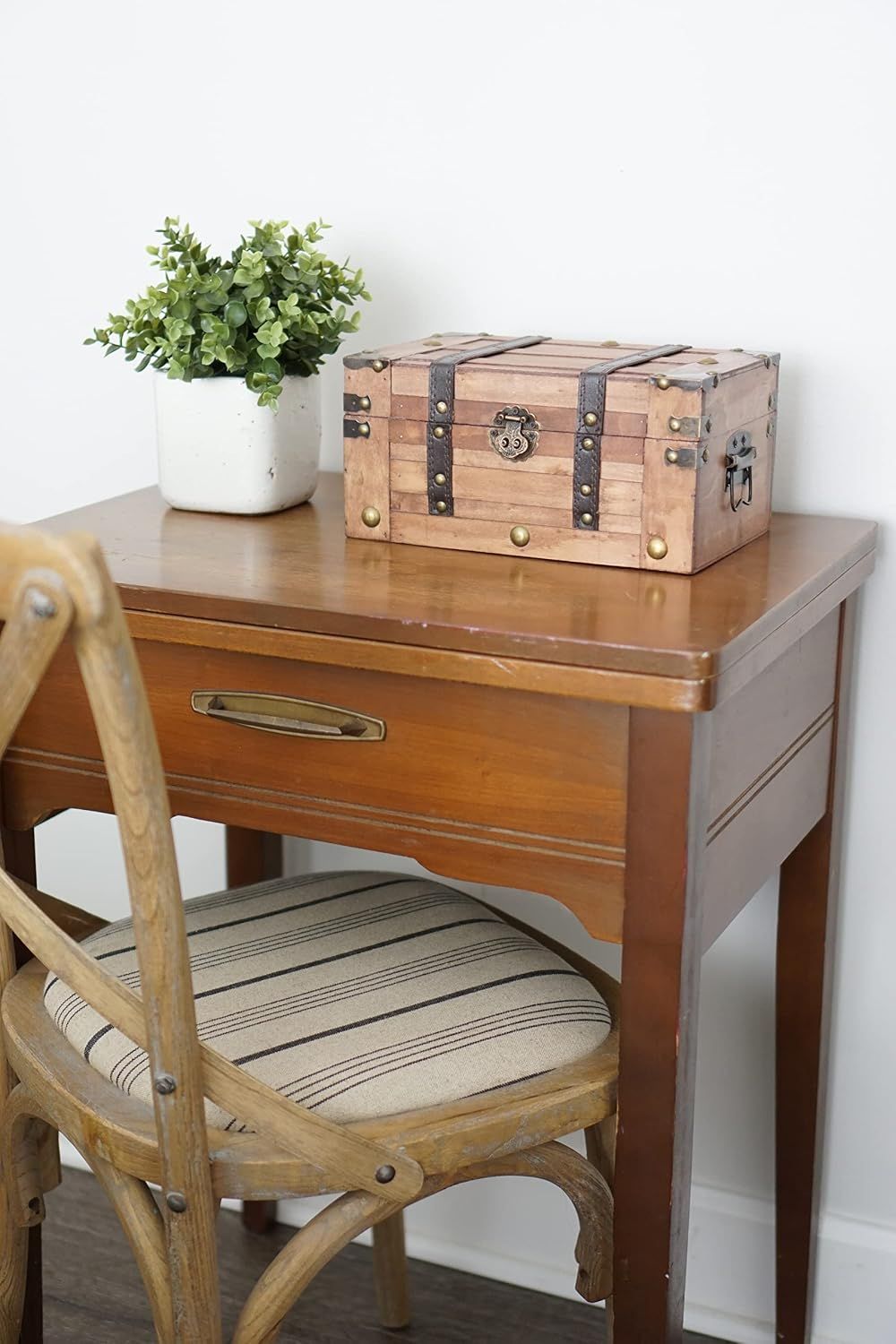 Shows the small trunk styled on a table to reassure shoppers it fits neatly into a home setting.