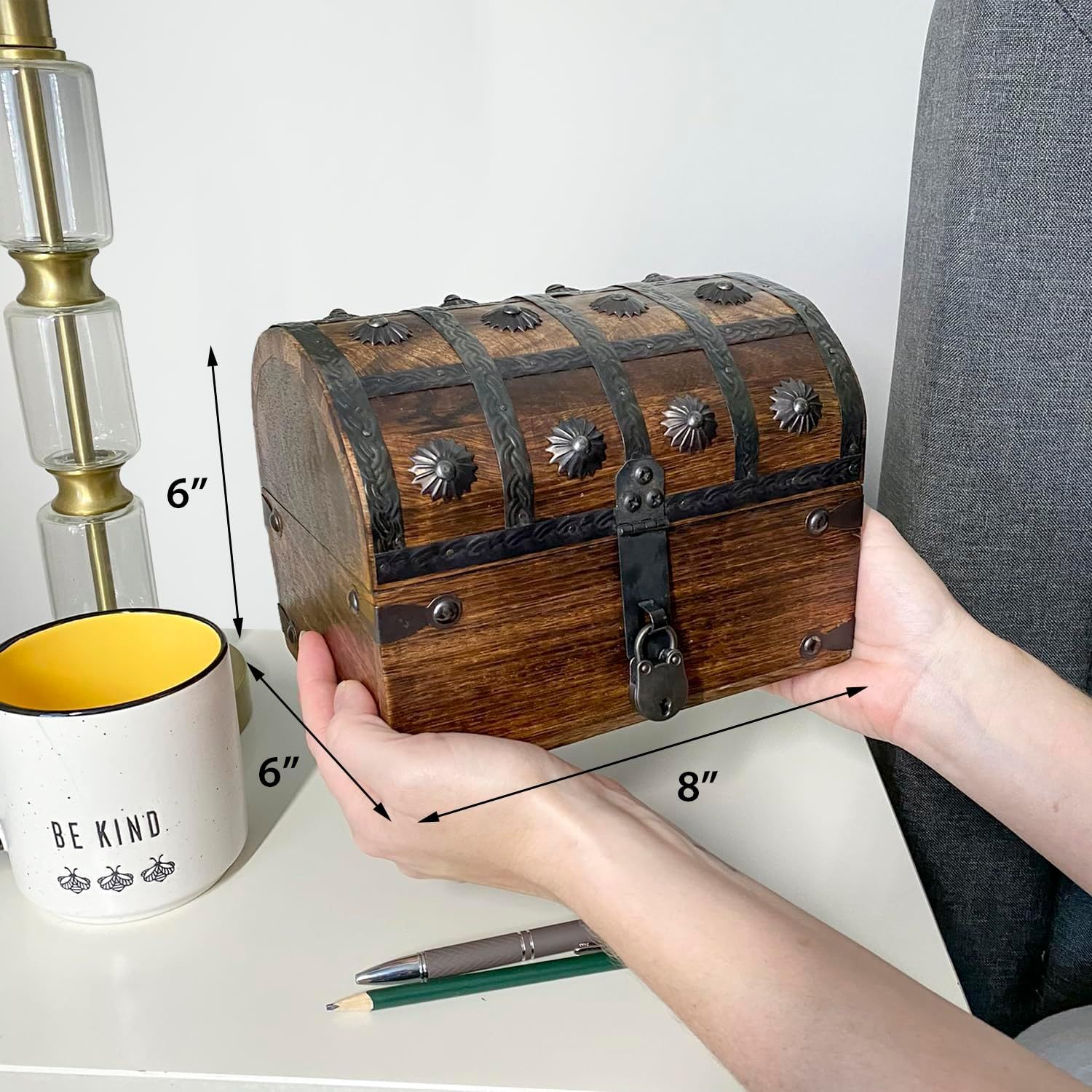Shows exact physical dimensions of the chest so shoppers know how big it is before buying. Reinforces that the chest is small enough to sit on a desk alongside everyday items.