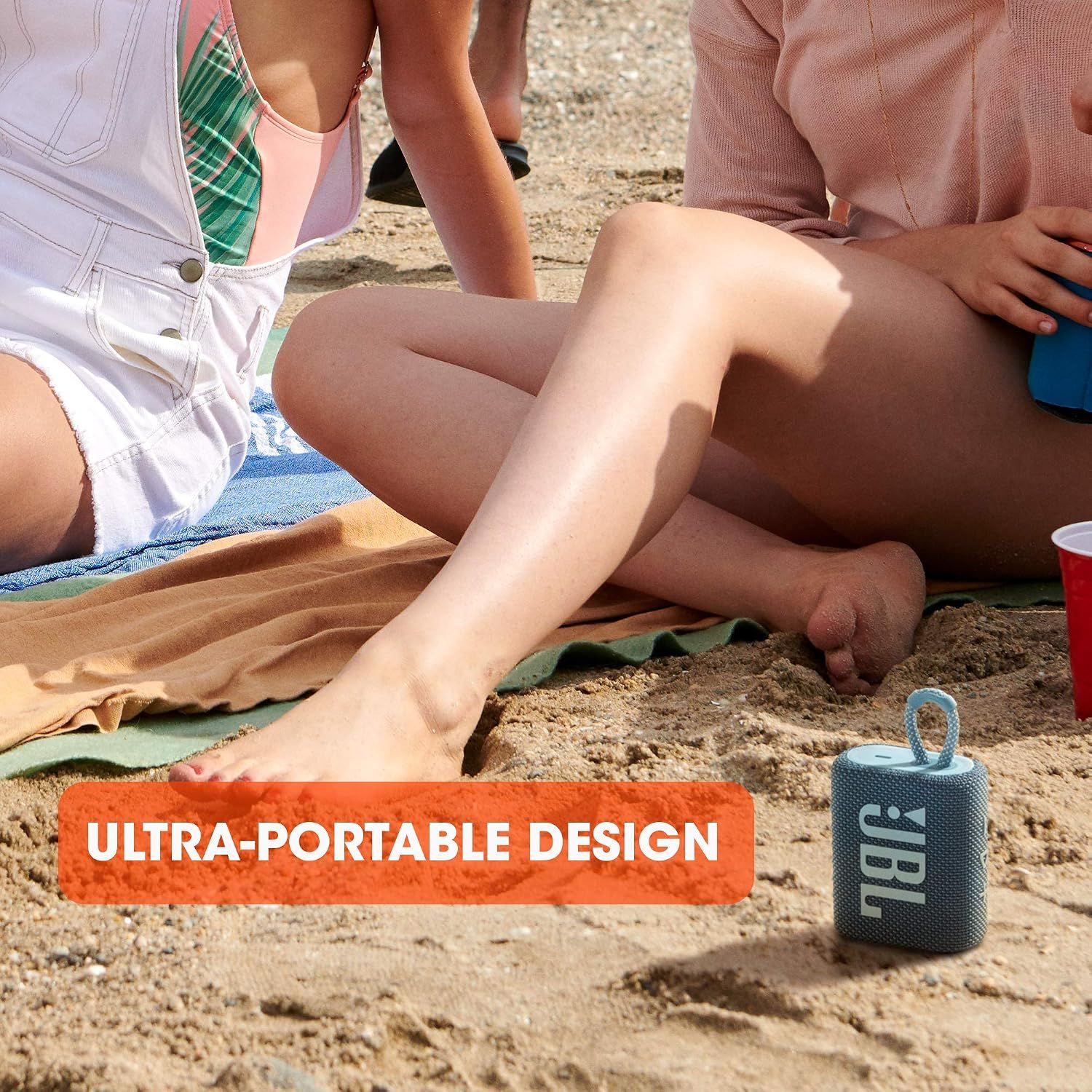 Shows the speaker is compact and easy to carry to the beach. Reassures shoppers it fits anywhere they go. Highlights the attached loop as a portable carrying feature.