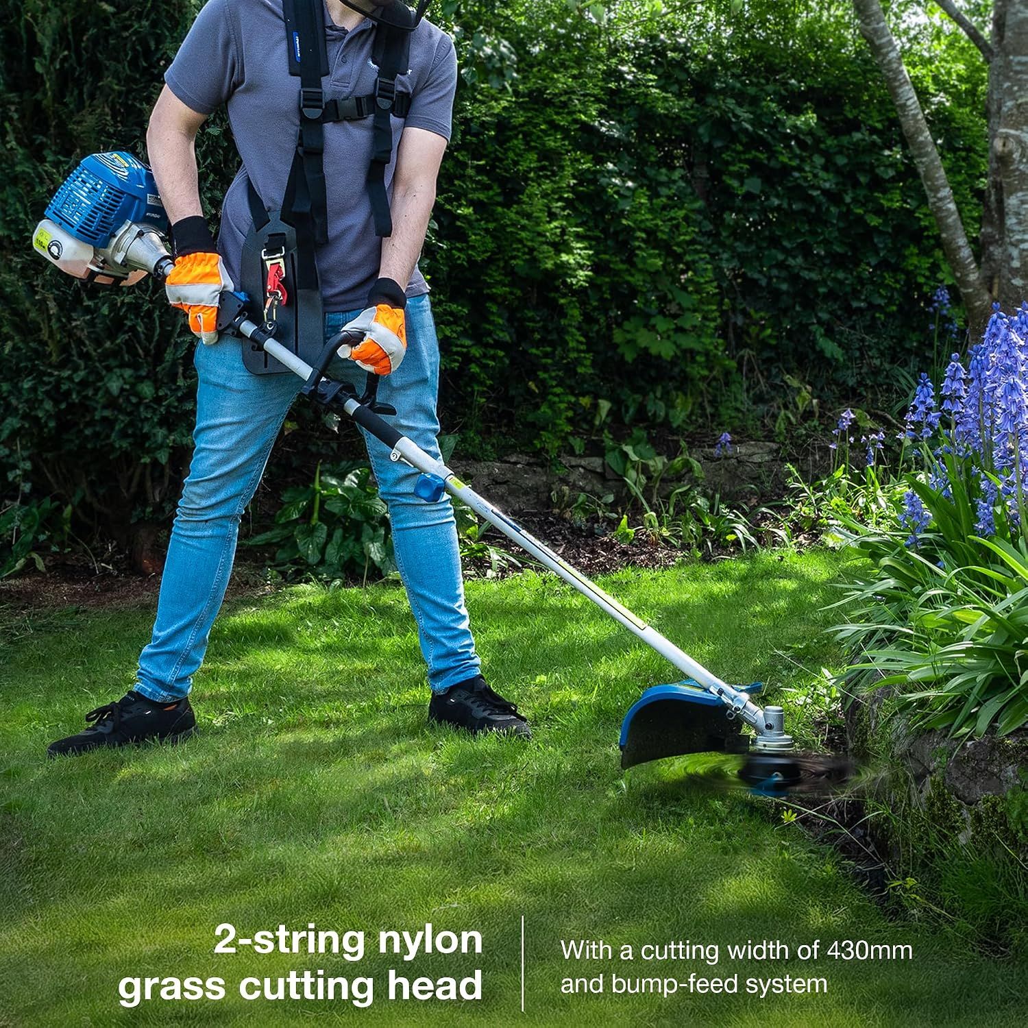 Demonstrates the grass cutting head in use and communicates its wide cutting width and easy bump feed. States the cutting width dimension of the grass trimmer head.