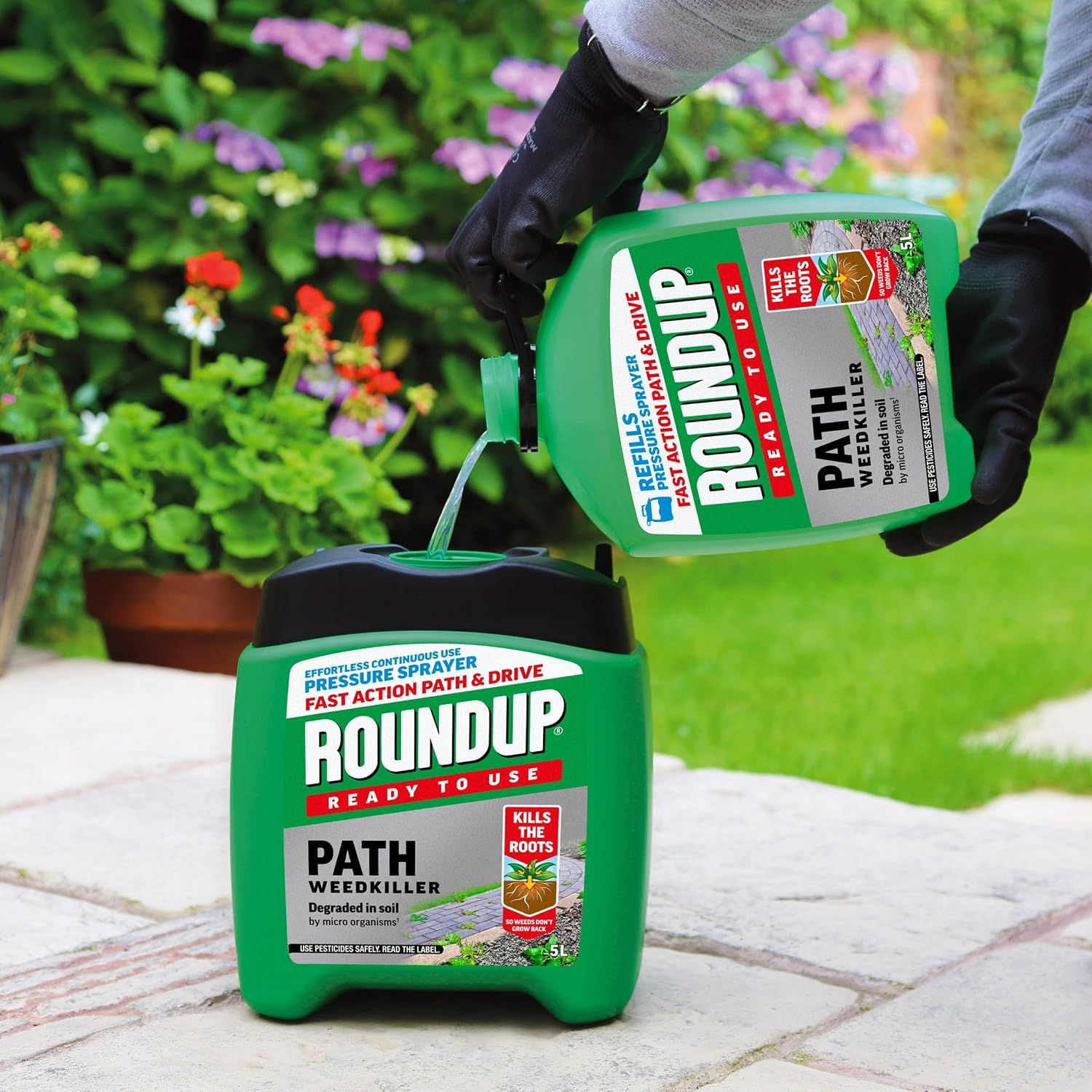 Shows the bottle being refilled into the pressure sprayer, conveying easy continuous use on paths.
