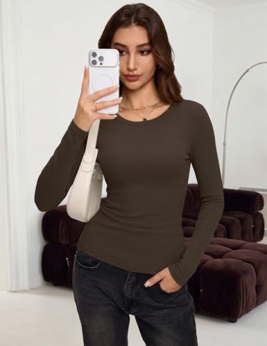 Shows the brown fitted top worn in a casual indoor setting to demonstrate everyday outfit potential.