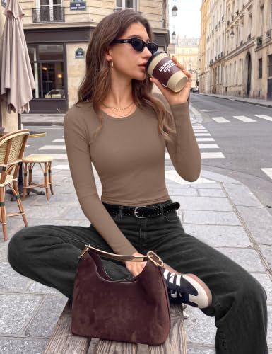 Shows the top styled with denim and accessories in a Parisian street setting to inspire outfit ideas.