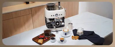 Shows the espresso machine in a real kitchen setting with coffee being made, inviting shoppers to picture it in their own home.