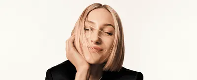 Uses aspirational, professional photography of a model to build an emotional, premium brand feel with no direct feature callout.