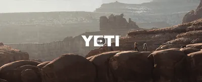 Uses an outdoor adventure video scene with the YETI logo to evoke the brand's rugged, outdoors lifestyle identity.