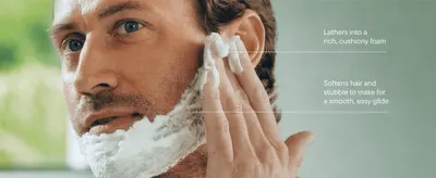 Shows the foam being applied to reassure shoppers it lathers richly and softens stubble for a smooth shave.