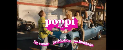 Uses a brand video still of friends at a retro drive-thru to build a fun, social feel around the drink. Reinforces the core claims of low sugar and prebiotics with a simple text overlay.