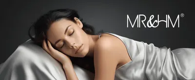 Shows a woman resting comfortably on the satin sheets to evoke the product's soft, luxurious feel.