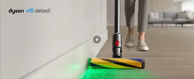 Shows the green laser illuminating invisible dust on the floor to prove the vacuum detects dirt a normal cleaner would miss.