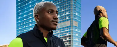 Shows the athlete wearing the apparel in an urban running setting to build an aspirational, on-brand mood.