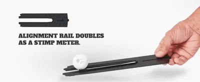 Demonstrates that the alignment rail doubles as a stimp meter to measure green speed. Shows a hand using the rail with a ball to demonstrate how the stimp meter function works in practice.
