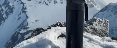 Shows the bottle in a rugged, extreme outdoor environment to build an aspirational, adventure-ready brand image.