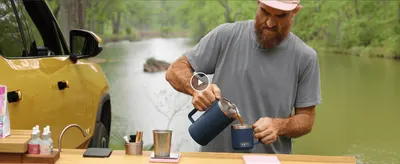 Shows the product being used in a real outdoor setting to build an aspirational, adventure-ready brand feel.