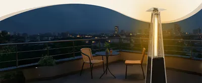Shows the heater on a city rooftop terrace to help shoppers envision cozy evening use in urban outdoor spaces.
