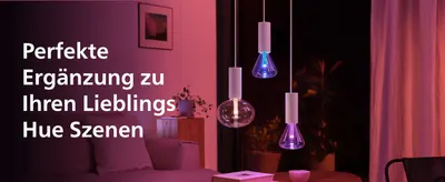 Shows the bulbs complementing Hue color scenes so shoppers understand they extend their existing smart lighting setup.