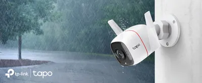 Shows the outdoor camera enduring heavy rain to reassure shoppers about weatherproof safety and reliable outdoor security.