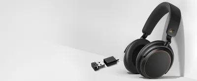 Shows the headphones beside the included BTD 600 dongle so shoppers know what arrives in the box.