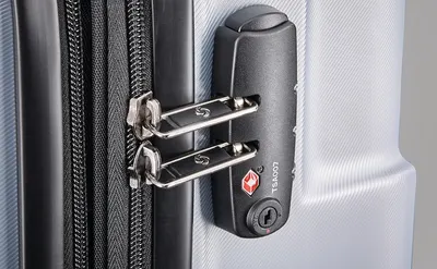 Close-up of the built-in TSA-approved lock shows shoppers the suitcase is secure for airport travel.