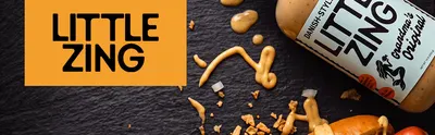 Establishes the Little Zing brand identity with a bold logo banner next to a styled product shot of the Danish-style Grandma's Original sauce bottle, building brand recognition and trust.