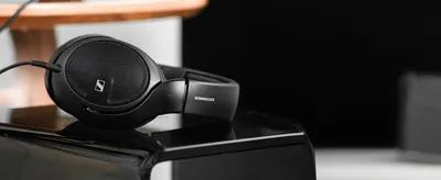Shows the open-back headphones in a calm listening room to help shoppers picture premium audio at home.