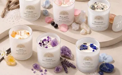 Shows the candle collection styled among crystals and botanicals to evoke a calm, natural ambiance that helps shoppers imagine the products in their own space.