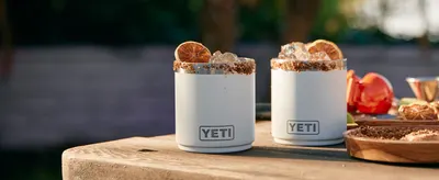 Displays the product in an appealing lifestyle context with beverages to help shoppers visualize product use and quality.