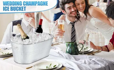 Shows the ice bucket set on a wedding reception table with champagne and wine, helping shoppers picture it at their own celebrations. Not applicable.