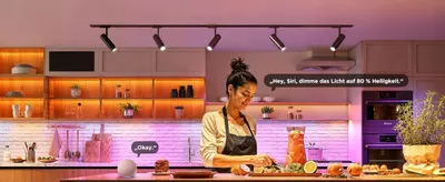 Shows the spotlights in a kitchen setting and voice control with Siri and Alexa to reassure shoppers the lights work with smart assistants. Highlights hands-free voice dimming to 80 percent…