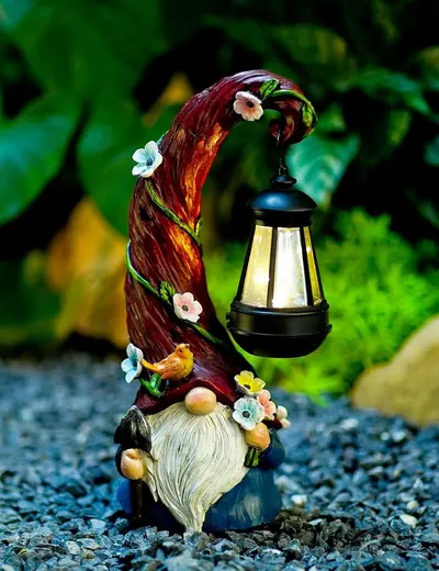 Showcases a decorative garden gnome with a solar lantern, highlighting its whimsical design and functionality as an outdoor lighting accessory.