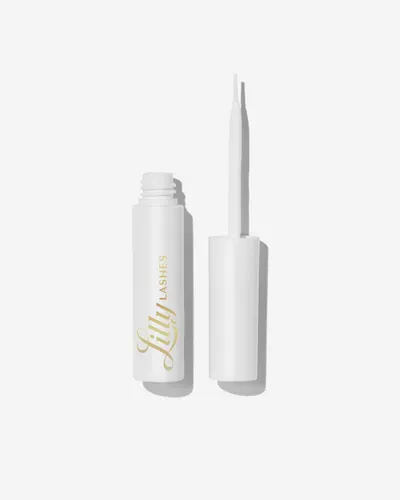 Showcases the product's sleek white packaging and applicator brush to highlight its premium quality and ease of use.