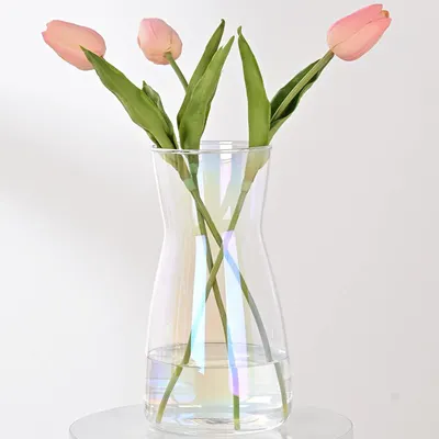 Showcases the product's elegant design and ability to display flowers beautifully. Demonstrates how the vase looks when in use, holding fresh tulips.