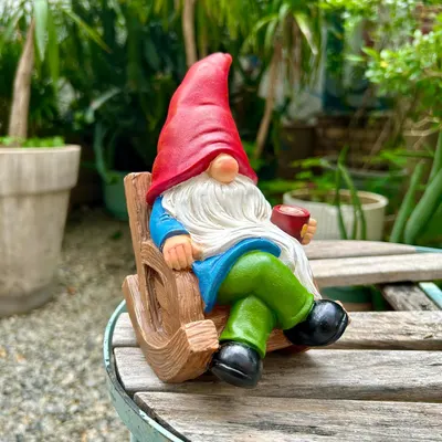 Showcases the product in a natural garden setting to demonstrate its use as a decorative outdoor item.