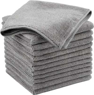 Showcases a stack of gray microfiber towels to highlight the product's quantity and texture.
