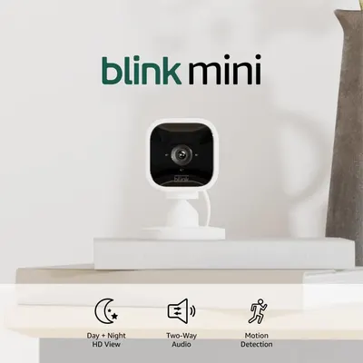 Showcases the Blink Mini security camera's small size and sleek design, emphasizing its compact nature for easy placement in the home.