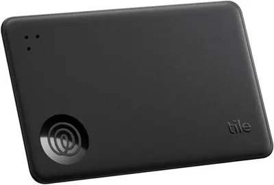 Showcases the sleek, compact design of the Tile tracking device against a plain background.