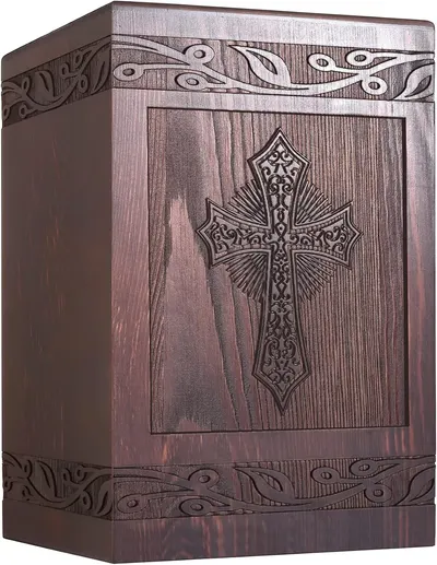Showcases the ornate design and craftsmanship of a memorial urn, highlighting its religious symbolism and aesthetic appeal.