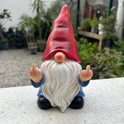 Showcases a quirky garden gnome product with a humorous gesture to appeal to customers looking for unique outdoor decor.