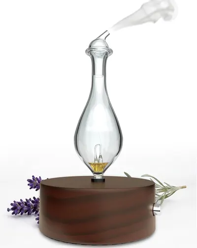 Showcases the product in a real-world context with natural elements like lavender and rosemary to communicate its use for aromatherapy and home ambiance.